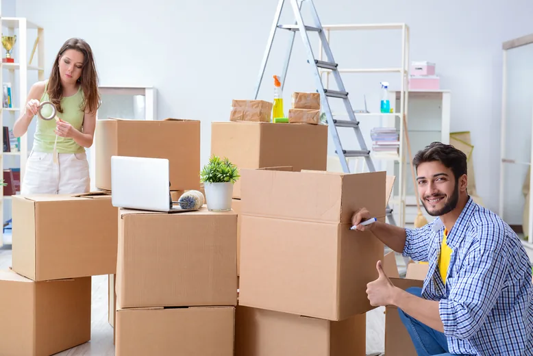 Happy family greeting their mover on a successful moving day